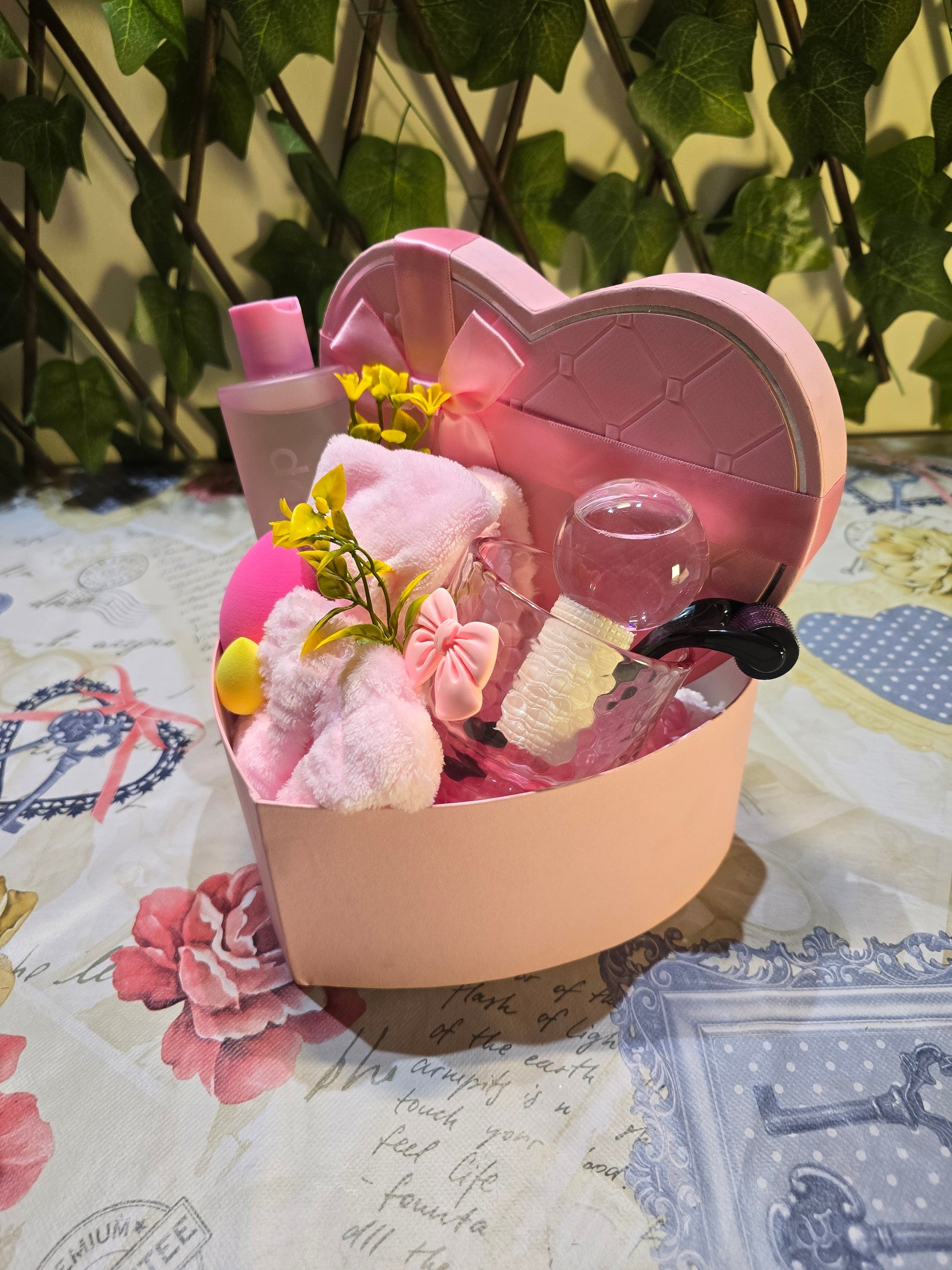 BioCode pink heart-shaped skincare gift set containing a facial cleanser, cooling globe, and plush hair accessories.