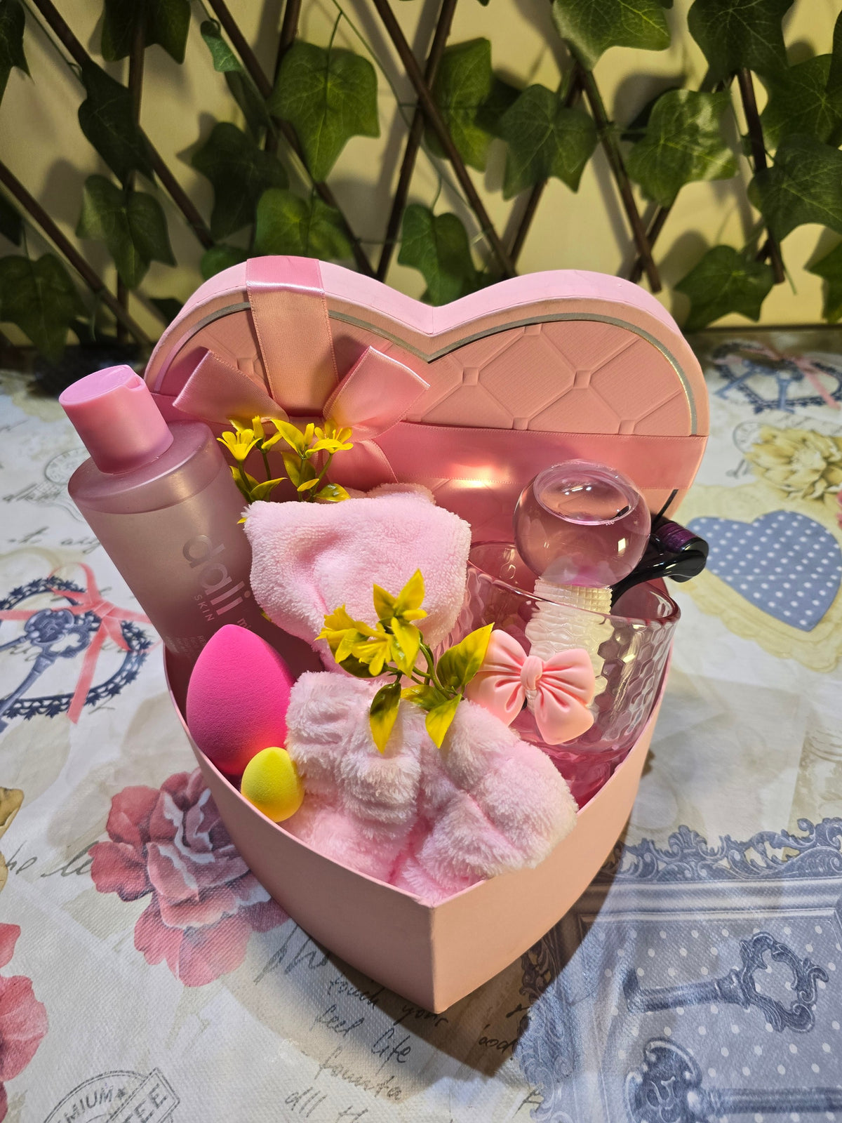 BioCode heart-shaped skincare gift set featuring pink facial cleanser, makeup sponges, hair accessories, and face globe.