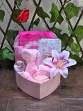 BioCode pink self-care gift set in a heart-shaped box featuring skincare, a bow wallet, and a cooling globe.