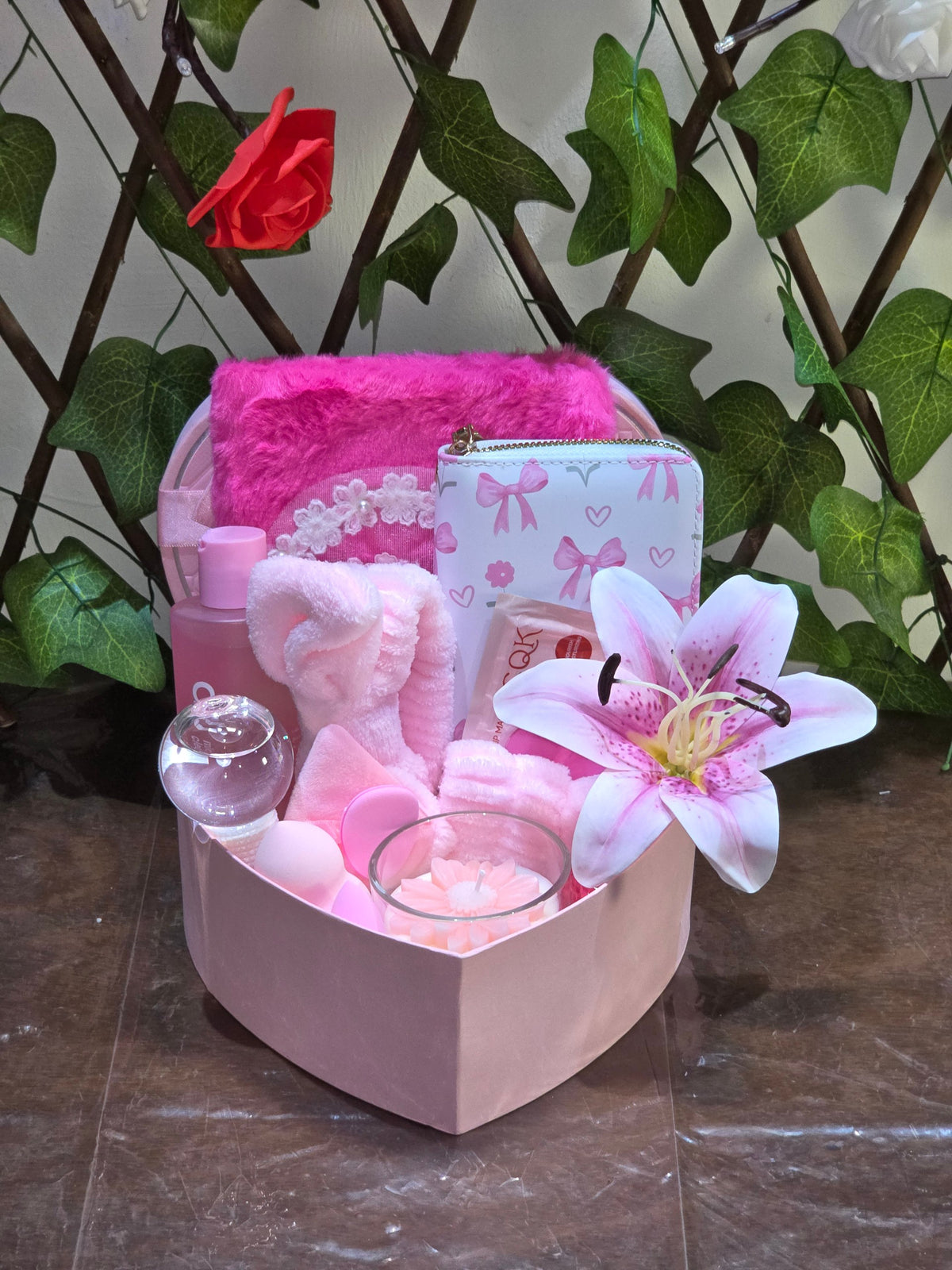 BioCode pink self-care gift set in a heart-shaped box featuring skincare, a bow wallet, and a cooling globe.