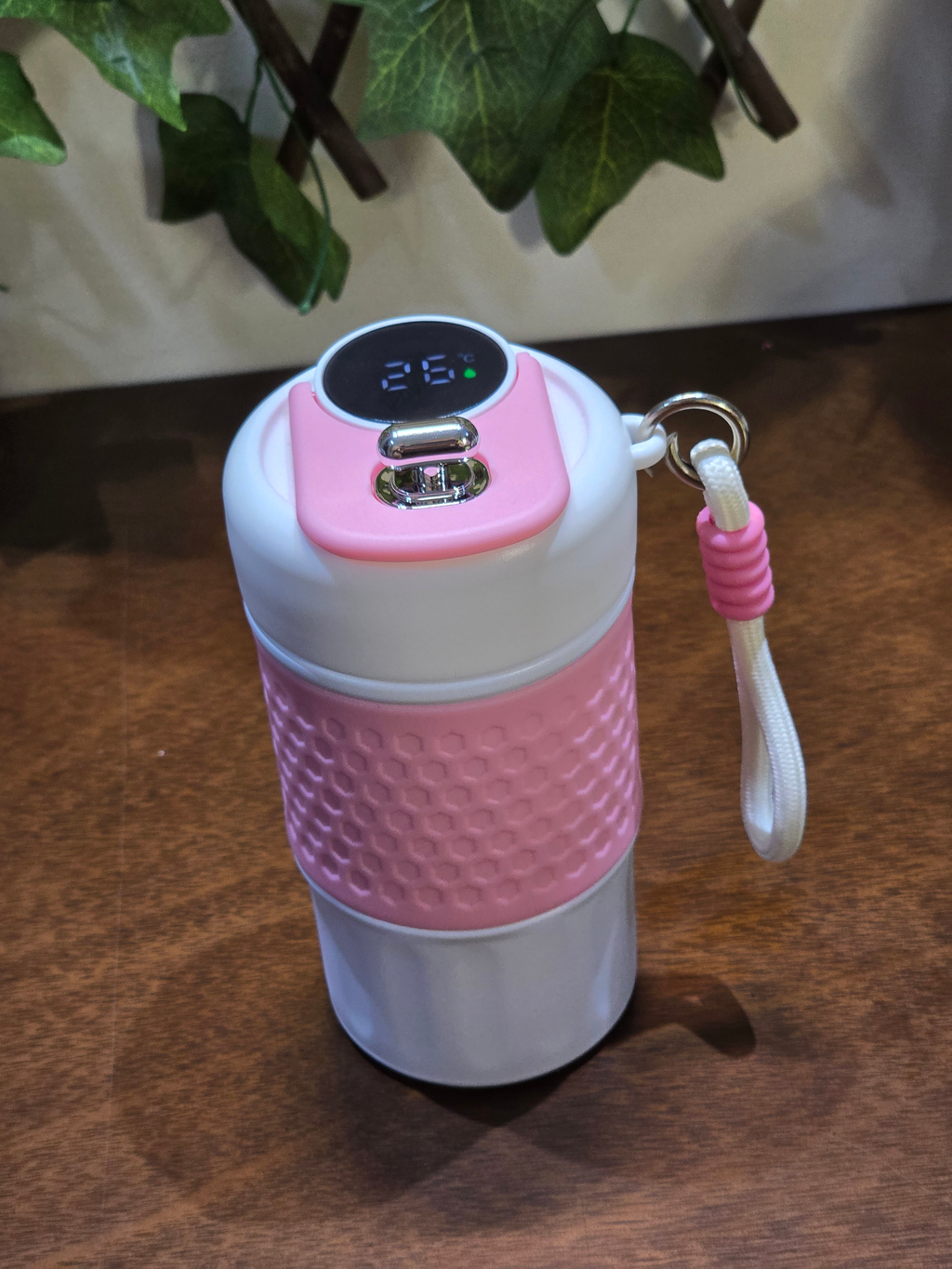 BioCode insulated travel mug in pastel pink and white with a honeycomb grip and digital temperature display lid