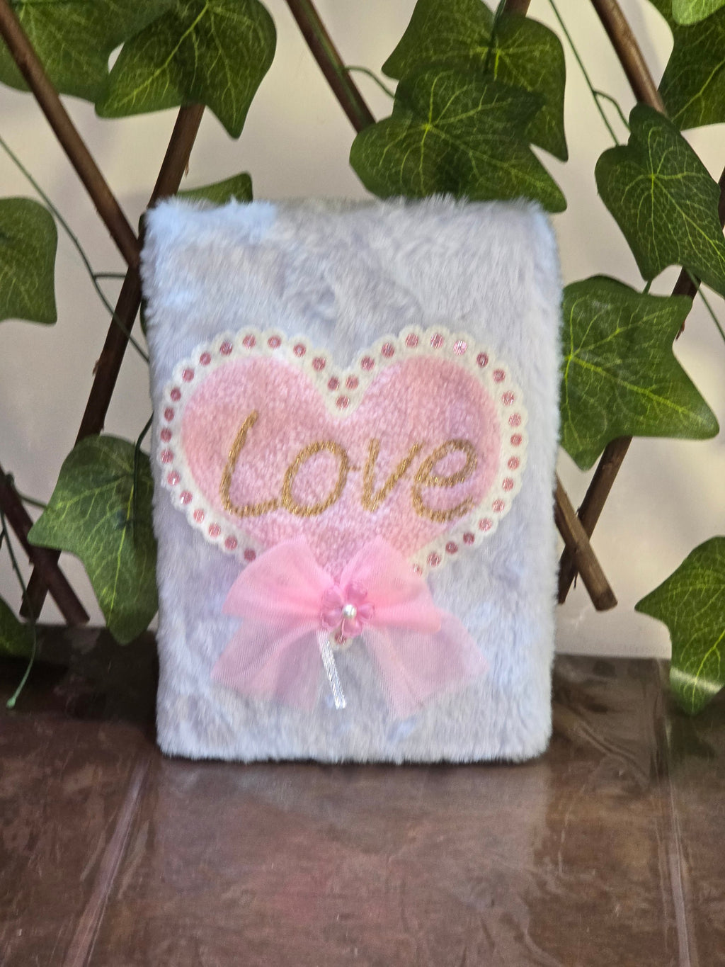 BioCode plush light purple notebook featuring a pink heart patch with the word Love and a decorative tulle bow.