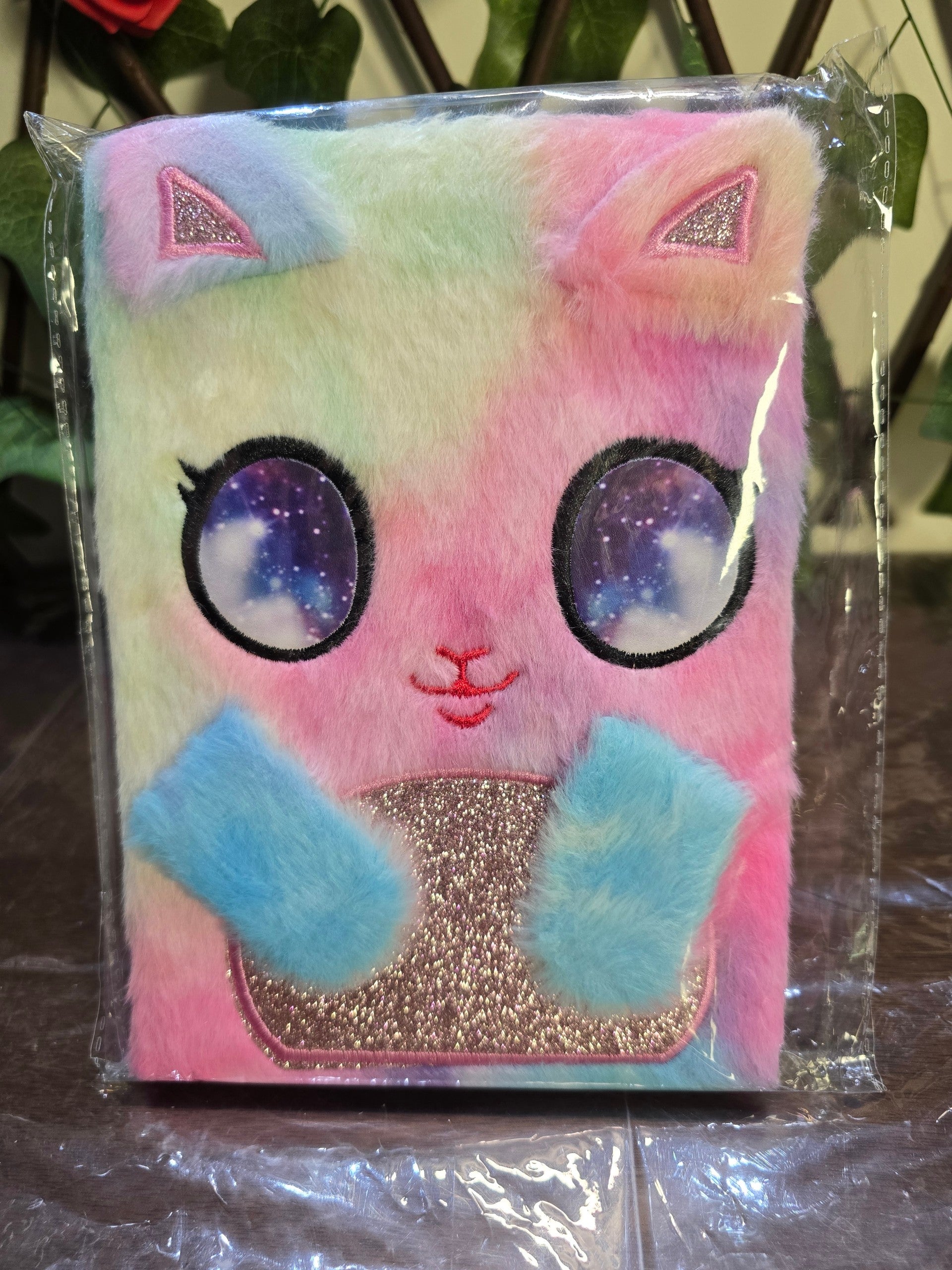 BioCode plush tie-dye cat notebook with galaxy eyes and glitter details in protective plastic packaging