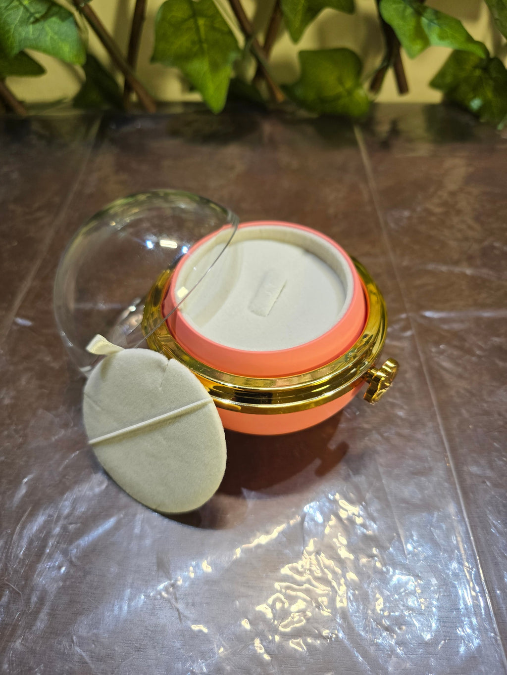 BioCode preserved rose jewellery gift box with a clear dome lid, gold-tone accents, and a soft cream ring insert.
