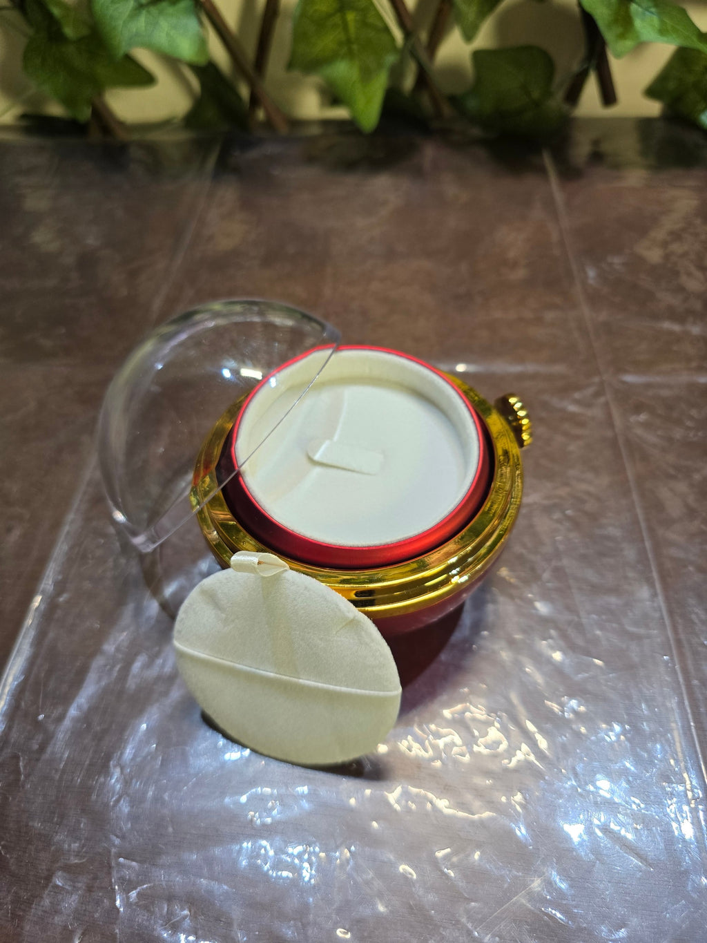 BioCode preserved rose jewellery gift box with a clear dome lid, gold-tone accents, and a plush white interior.