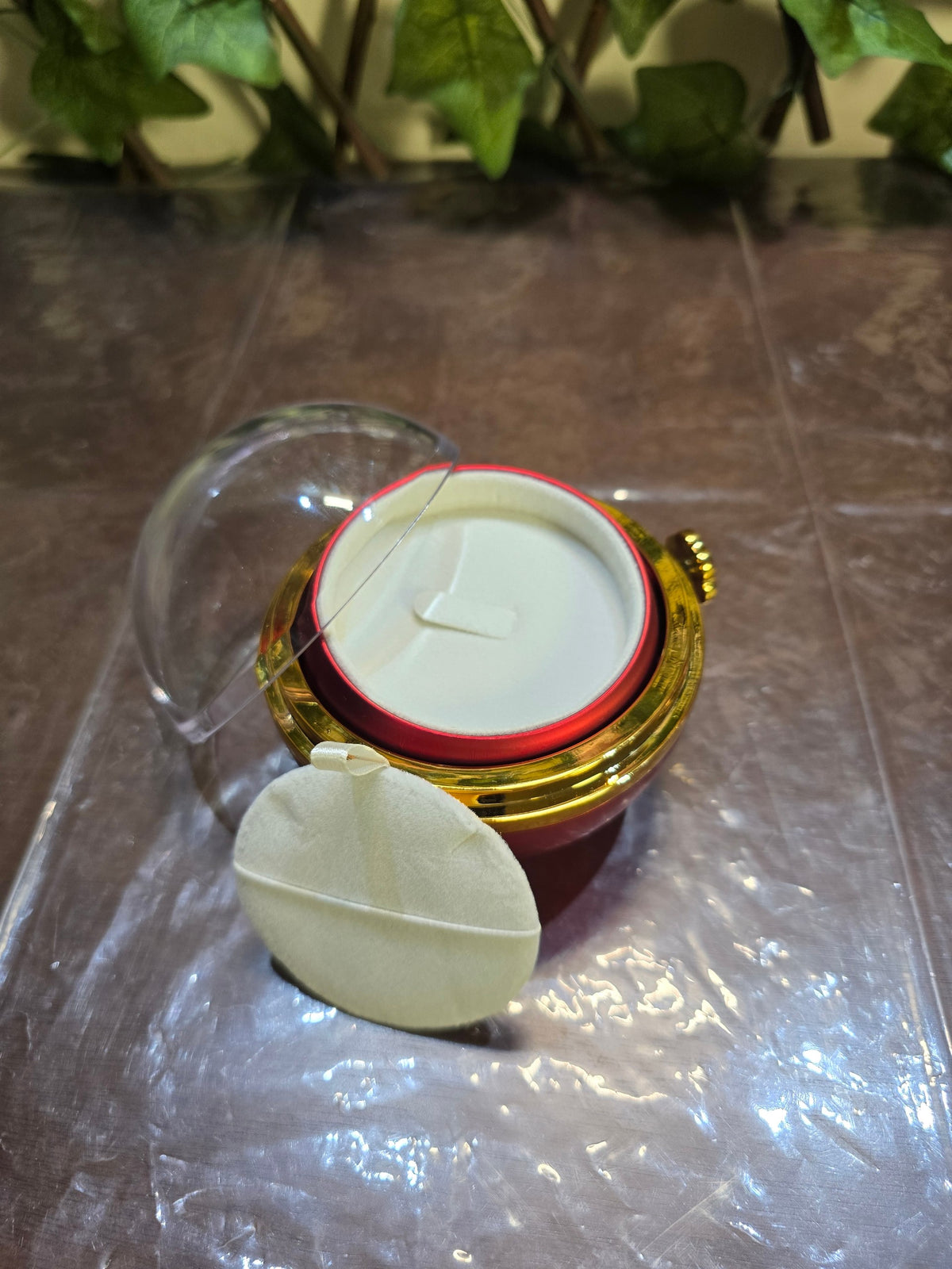 BioCode preserved rose jewellery gift box with a clear dome lid, gold-tone accents, and a plush white interior.