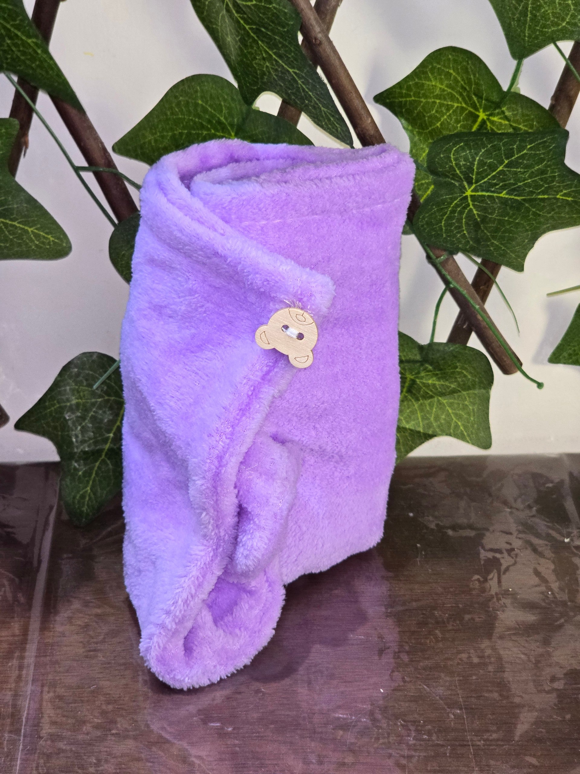BioCode soft purple plush skincare headband with a cute bear-shaped wooden button detail