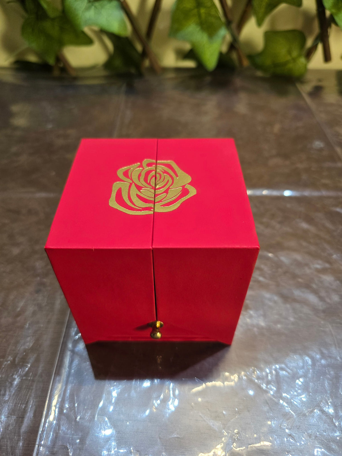 BioCode red jewellery gift box featuring a gold rose motif on the lid and a small gold handle on the front drawer