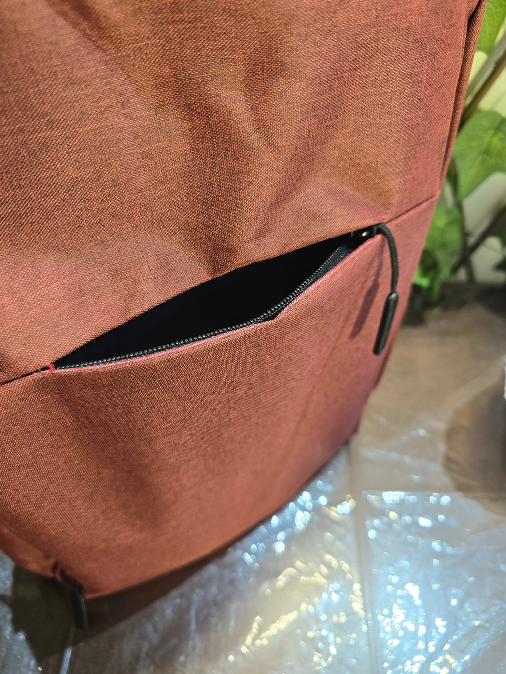 BioCode deep red laptop backpack featuring a secure front zip pocket with a minimalist design and durable fabric