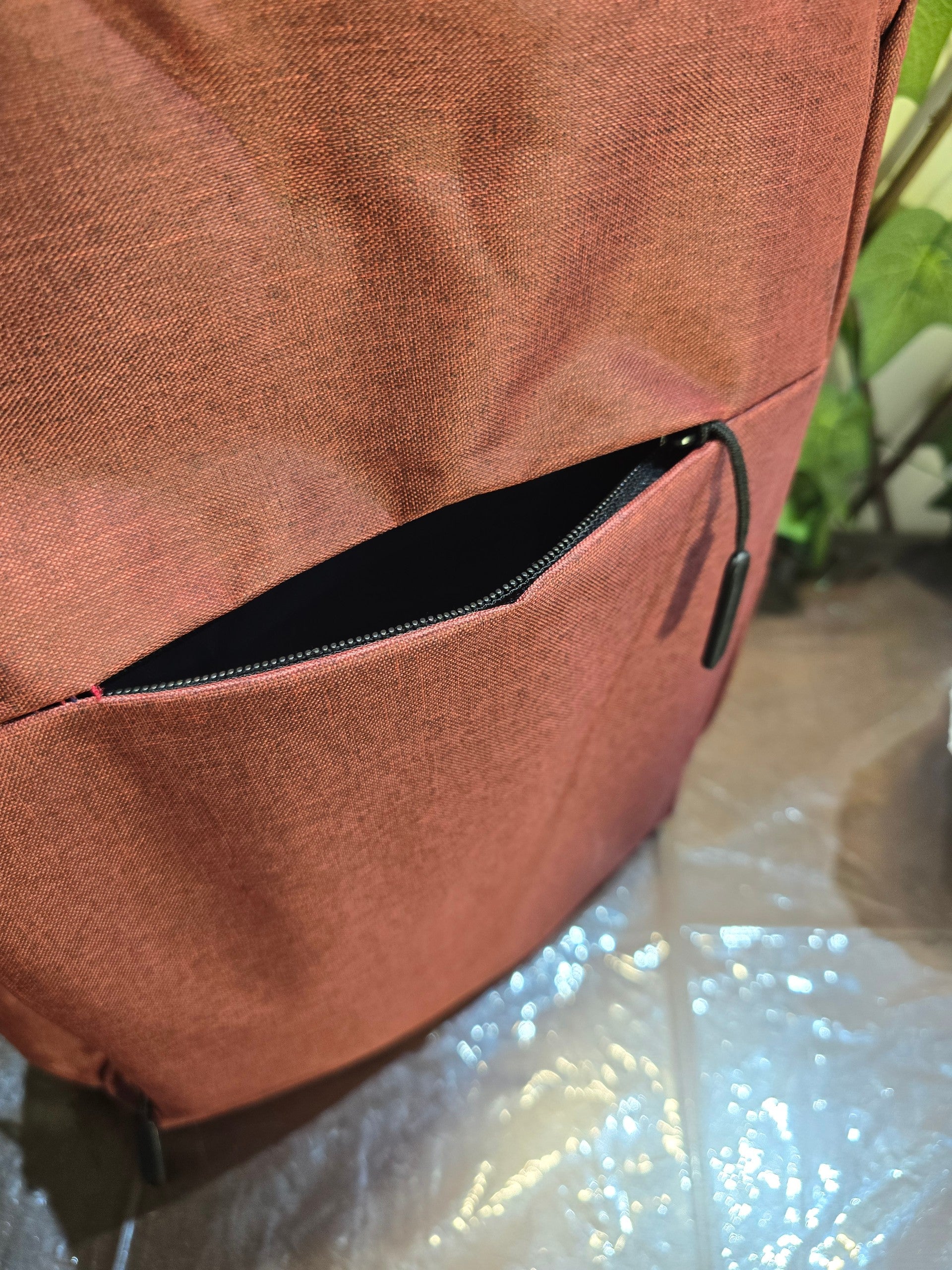 BioCode deep red laptop backpack featuring a secure front zip pocket with a minimalist design and durable fabric