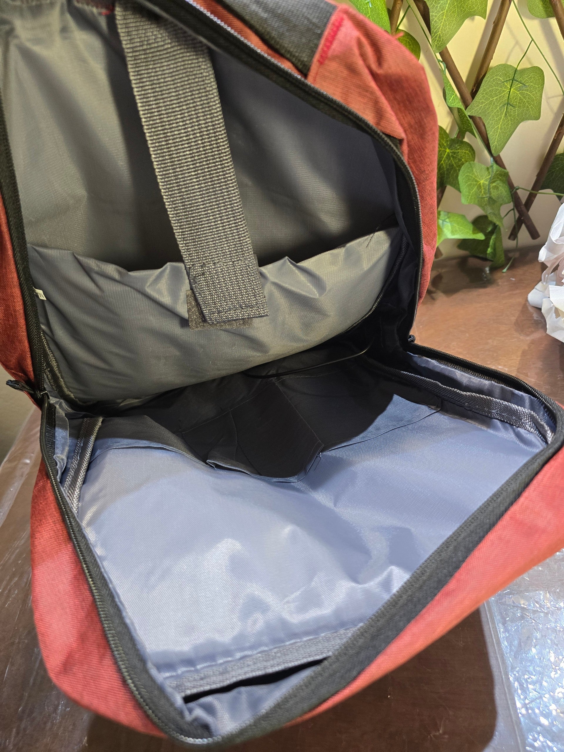 BioCode deep red laptop backpack interior showing a padded laptop sleeve and spacious main compartment