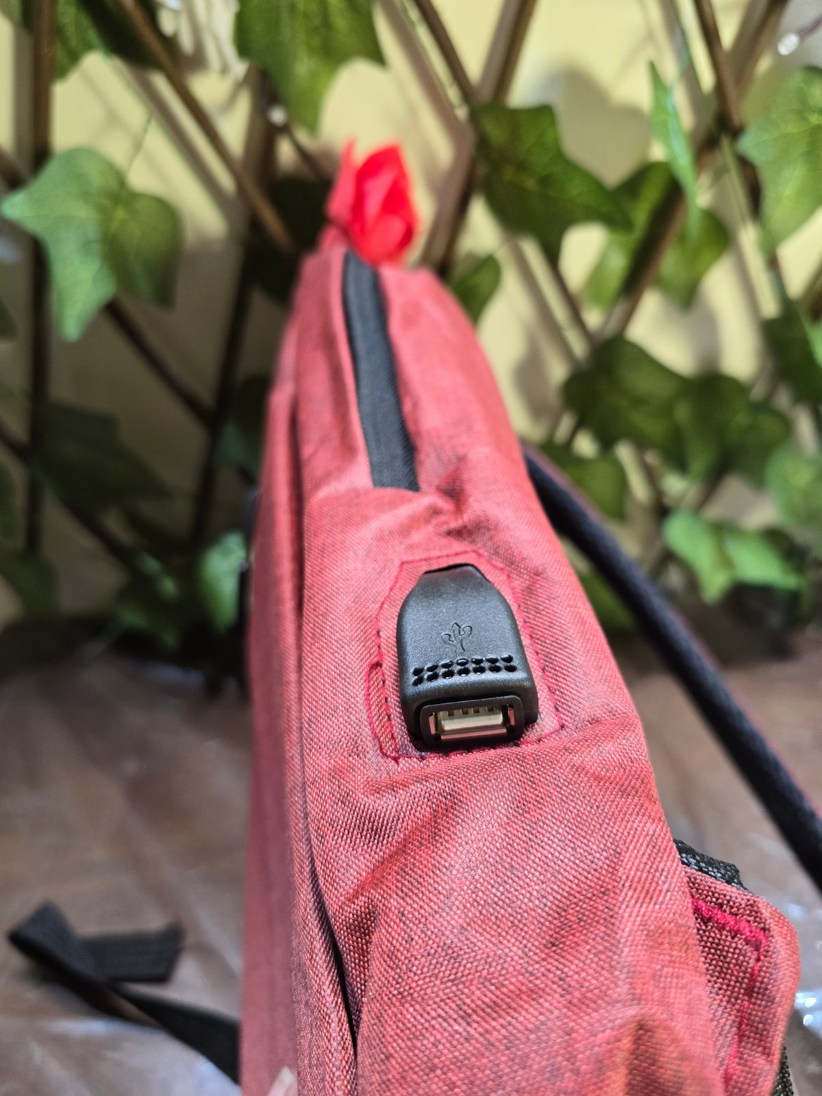 BioCode deep red laptop backpack featuring an integrated external USB charging port and durable fabric construction