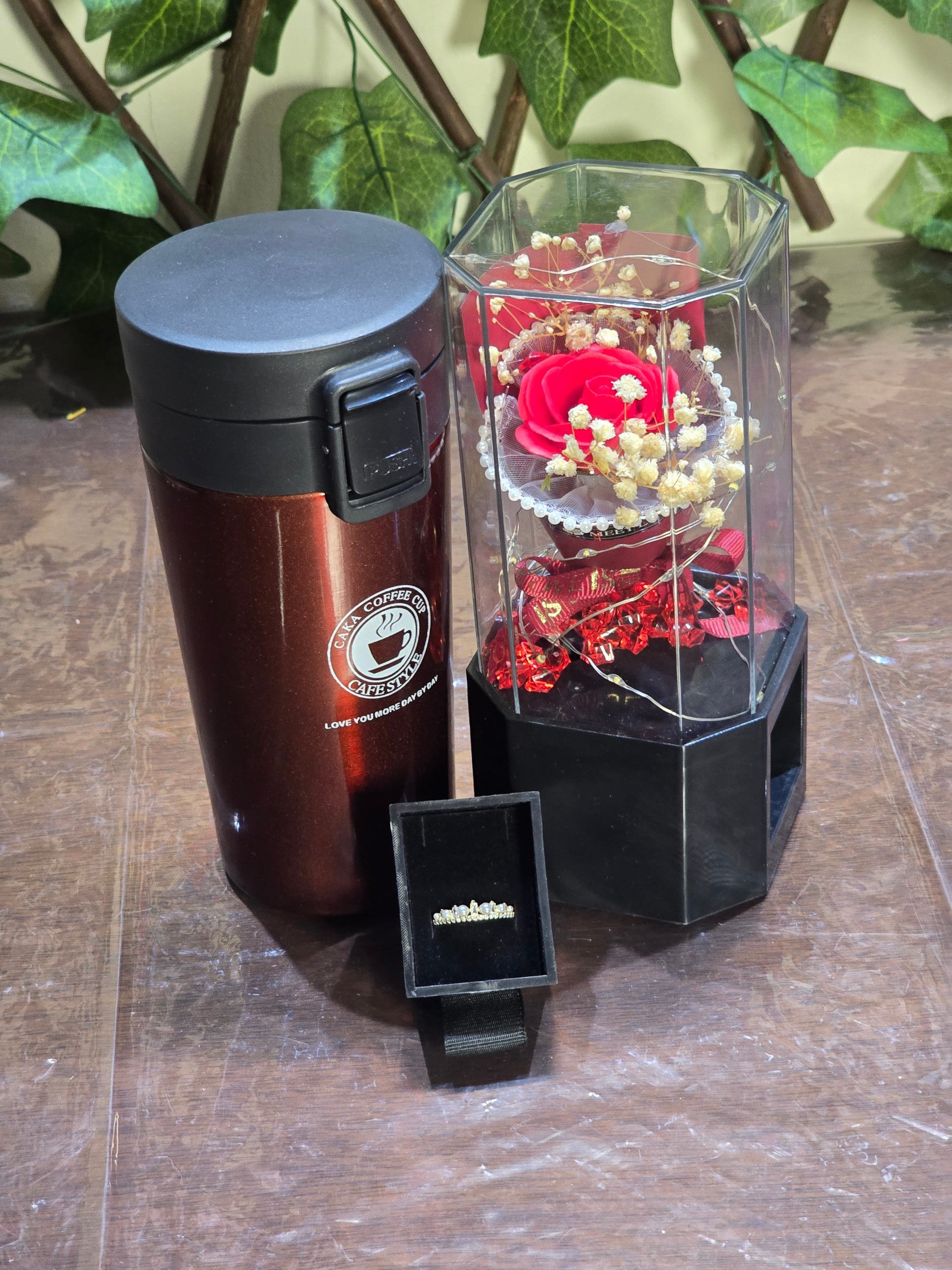BioCode romantic gift set featuring a metallic brown vacuum cup, a preserved red rose in a light-up case, and a ring.