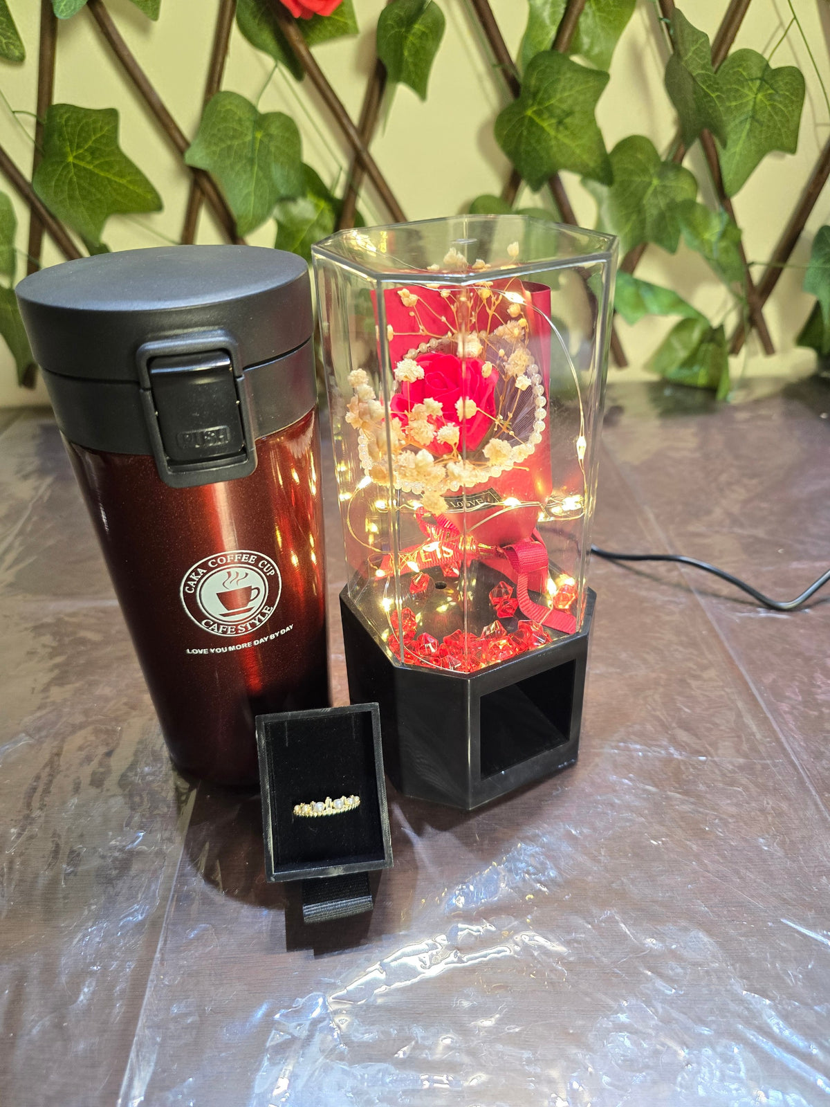BioCode romantic gift set featuring a metallic red vacuum cup, a preserved rose in a light-up case, and a pearl ring.