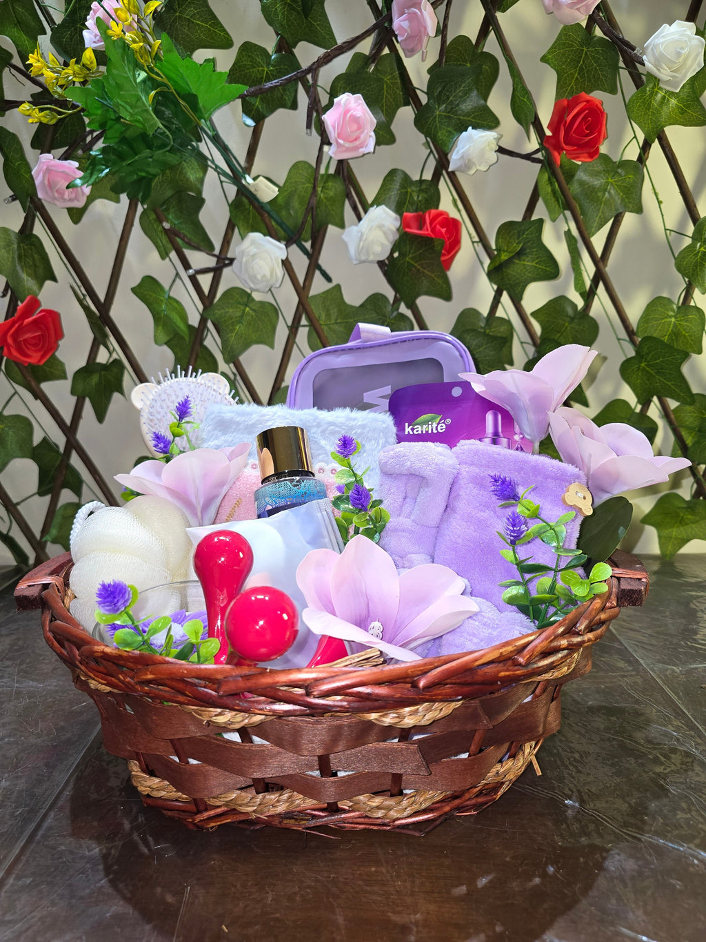 BioCode deluxe self-care gift hamper in a woven basket with purple spa accessories, skincare, and floral decor.
