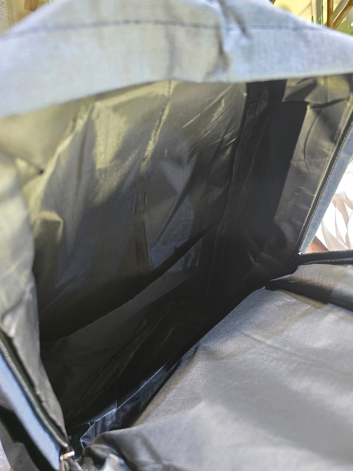 Interior view of the slate-blue BioCode backpack showing the spacious main compartment and durable fabric lining.