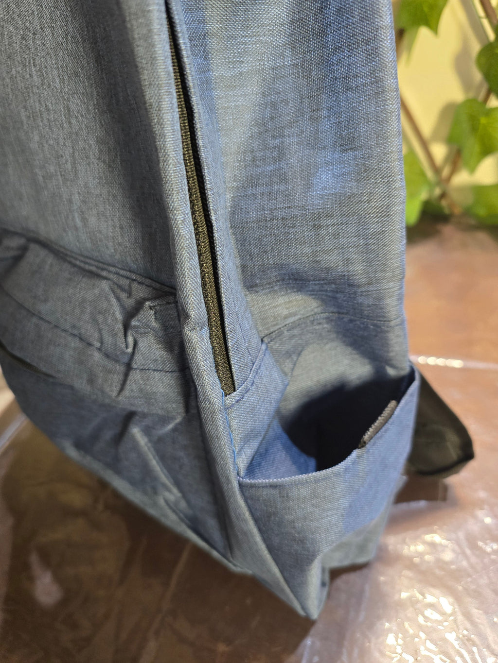 BioCode slate-blue textured fabric backpack with side pocket and zip detail for daily travel and organisation