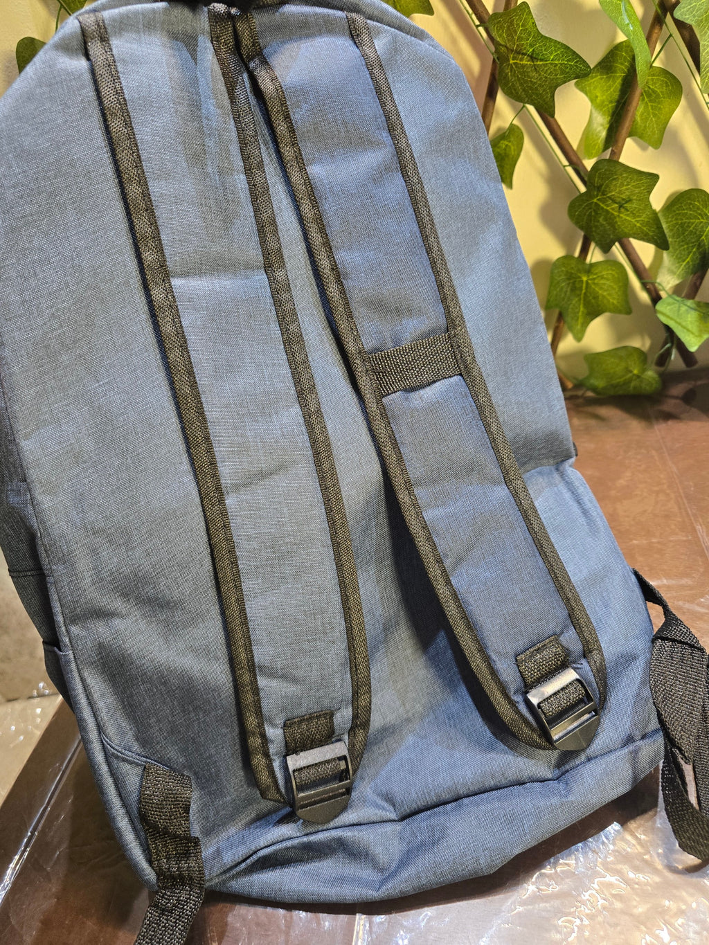 BioCode slate-blue minimalist backpack with adjustable padded shoulder straps and durable textured fabric