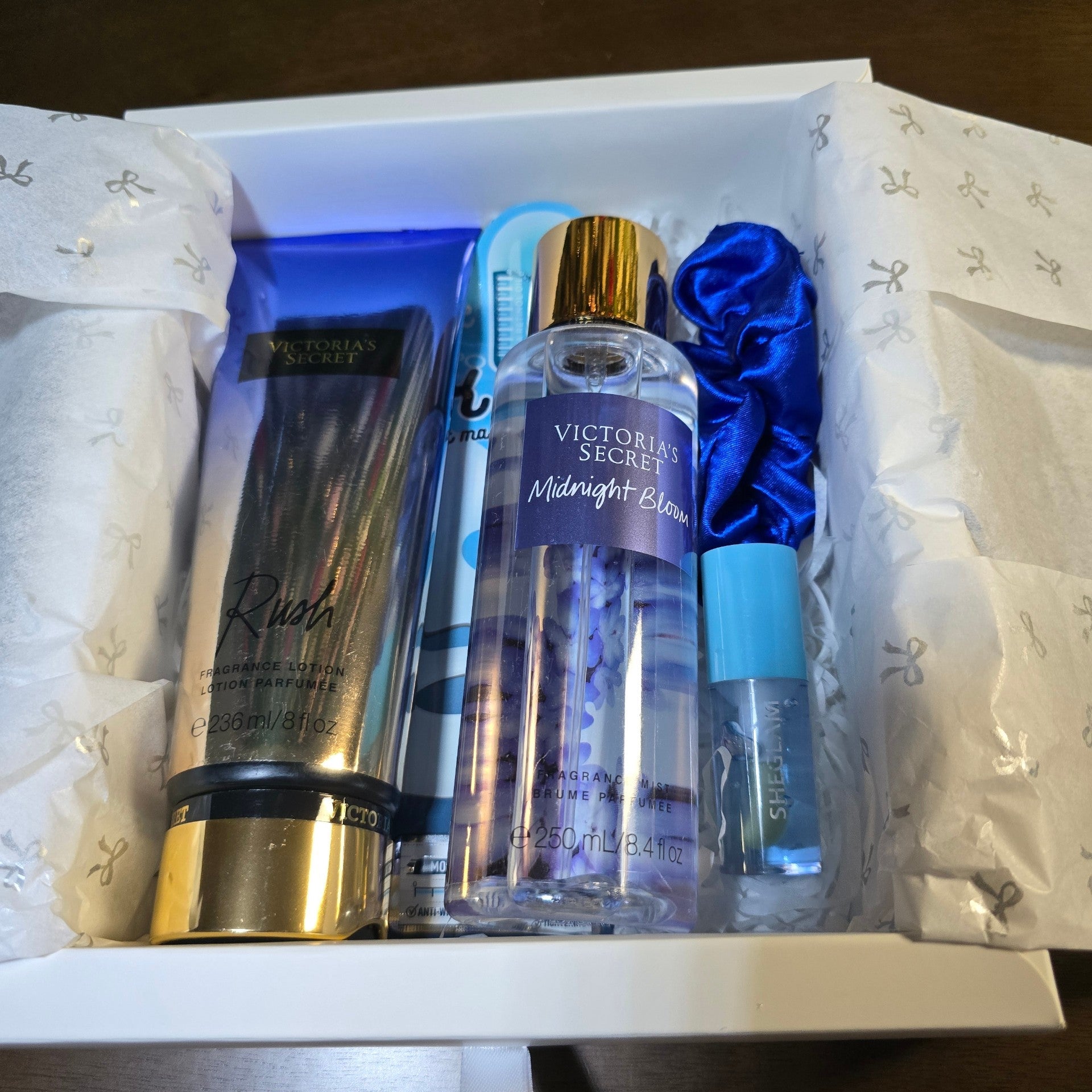 BioCode Victoria's Secret fragrance gift set featuring Rush lotion, Midnight Bloom mist, blue scrunchie, and lip gloss.