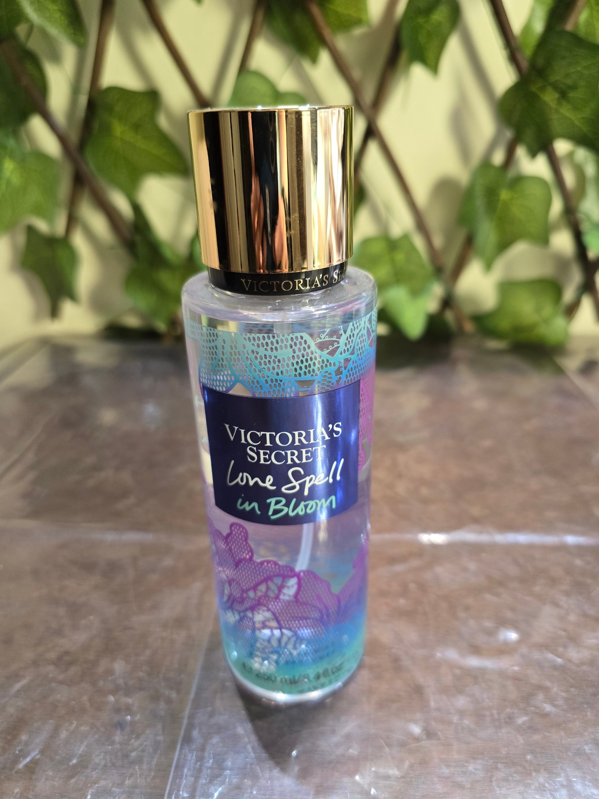 BioCode Victoria's Secret Love Spell in Bloom fragrance mist in a clear bottle with a gold cap and floral label